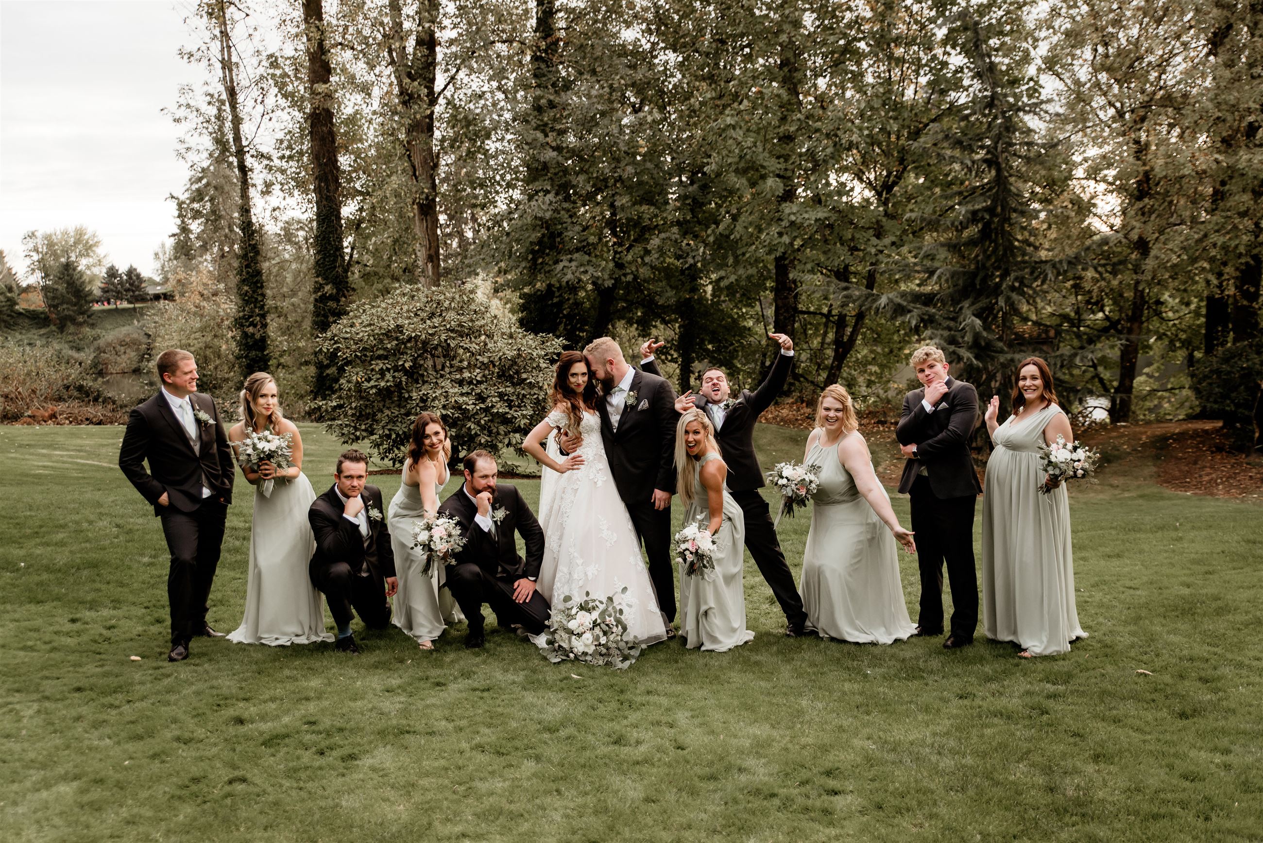 Bride and groom fun photo posing with bridal party