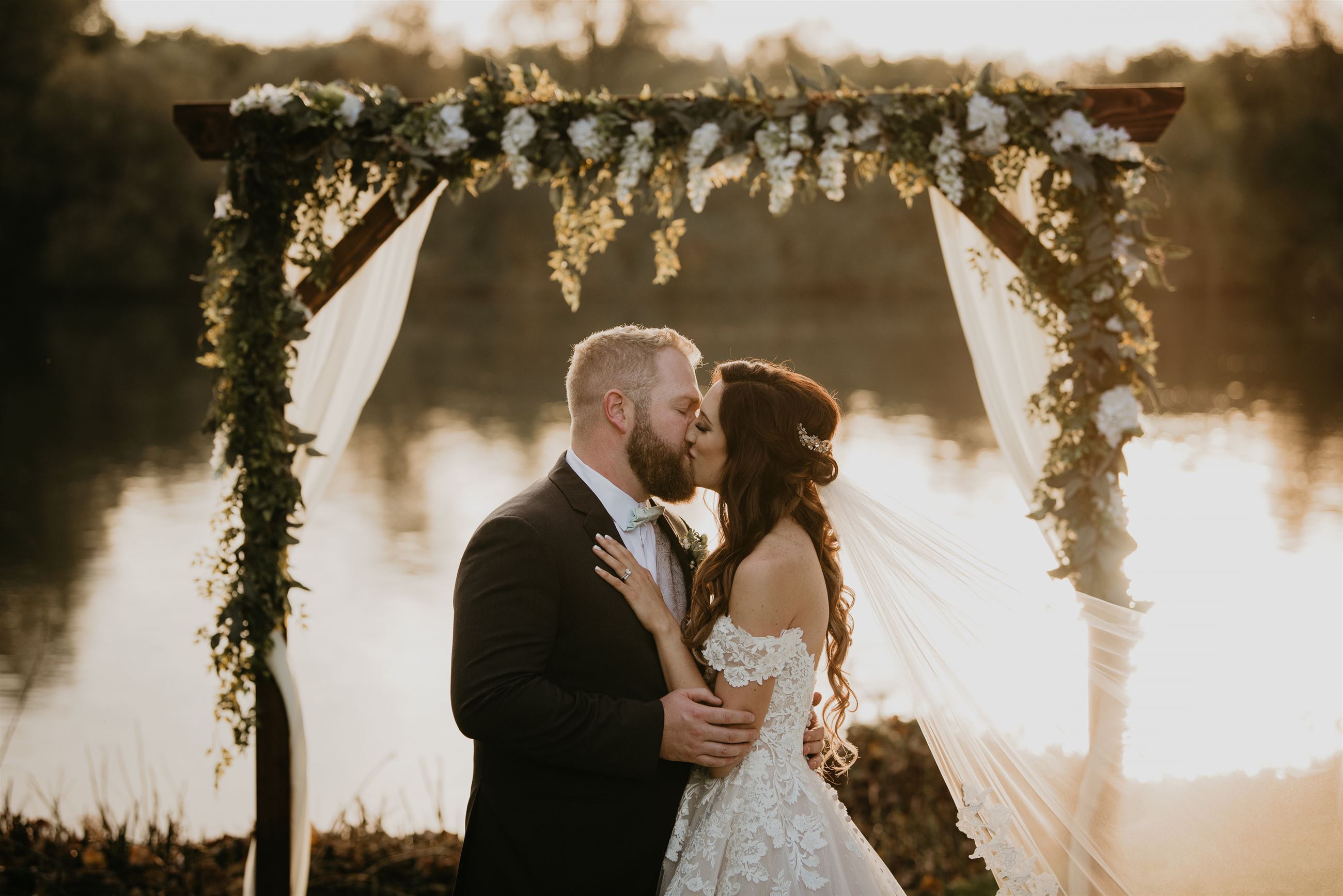 bride and groom kissing at the altar