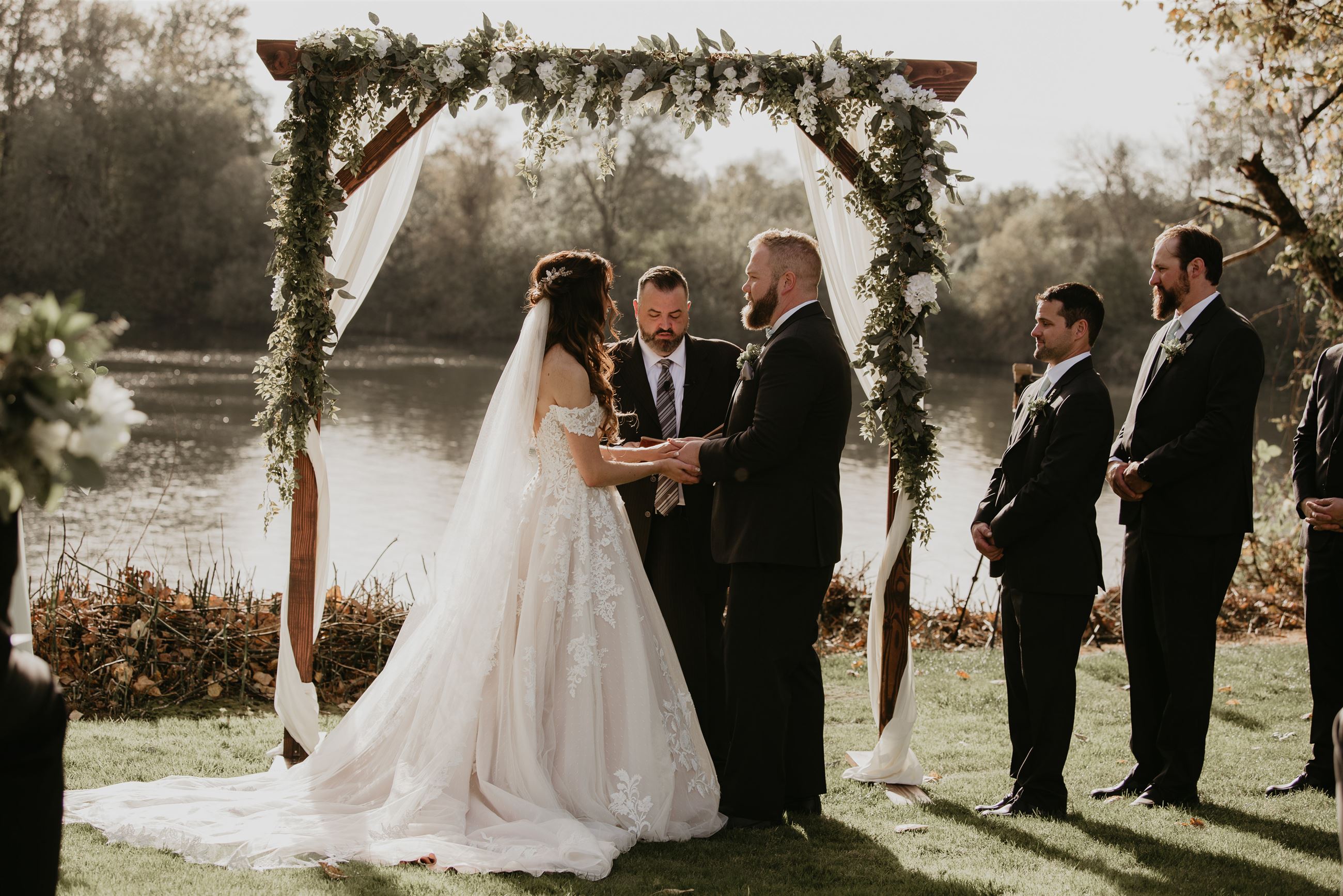 Bride and groom holding hands at altar