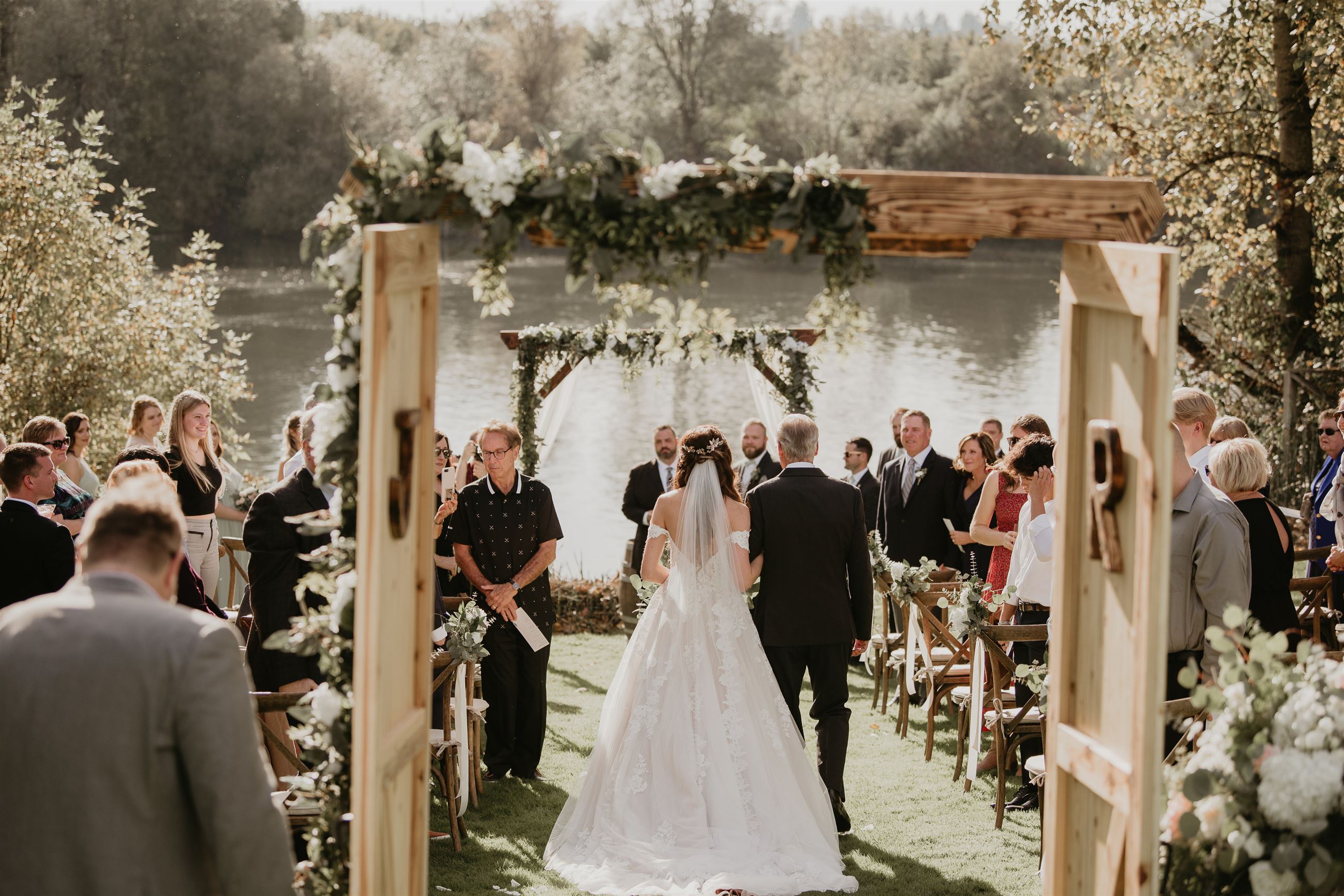 bride walking down the aisle to the alter with her father