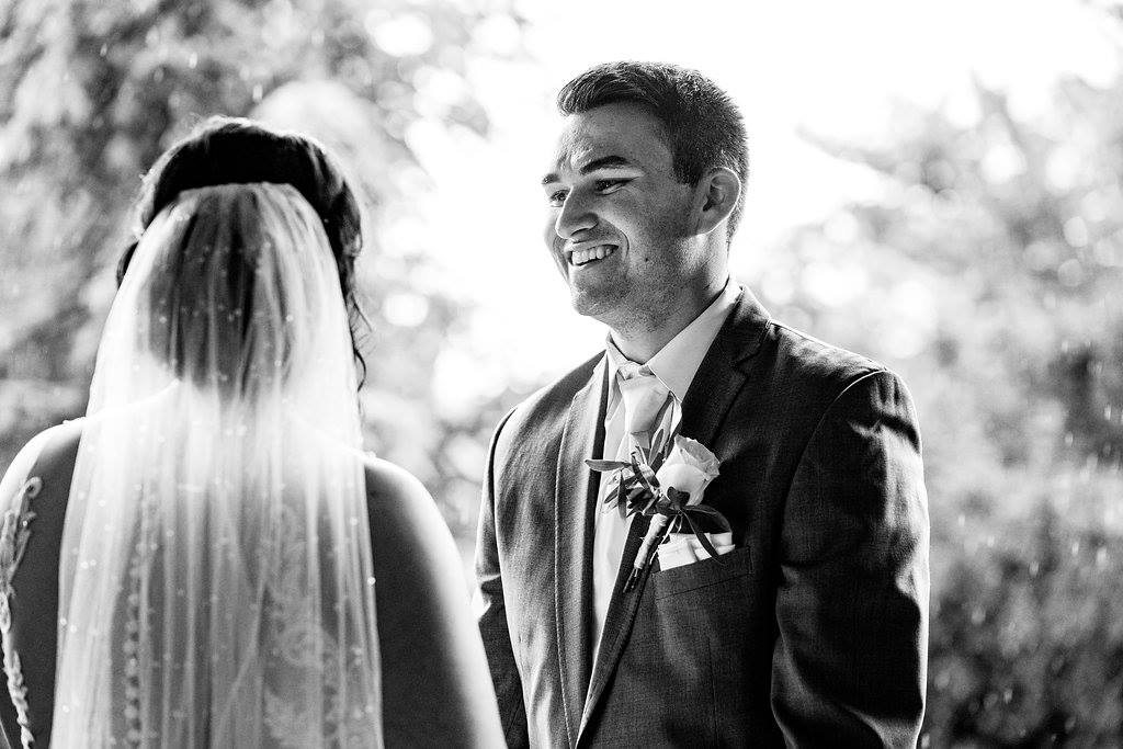 Groom, Justin smiling at his bride, Jensen!