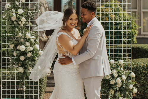 bride and groom hugging at altar