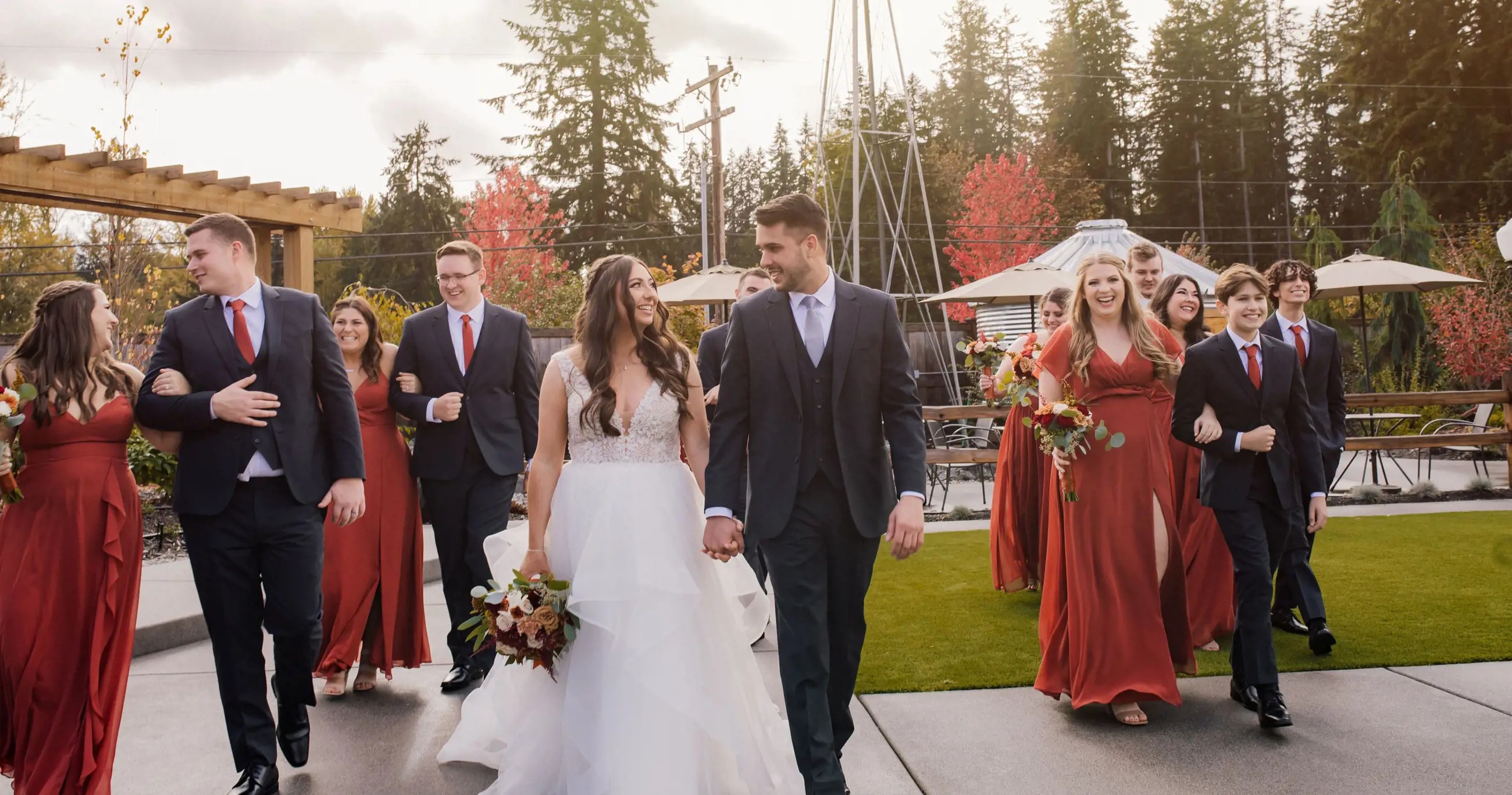 bride & groom walking with wedding party