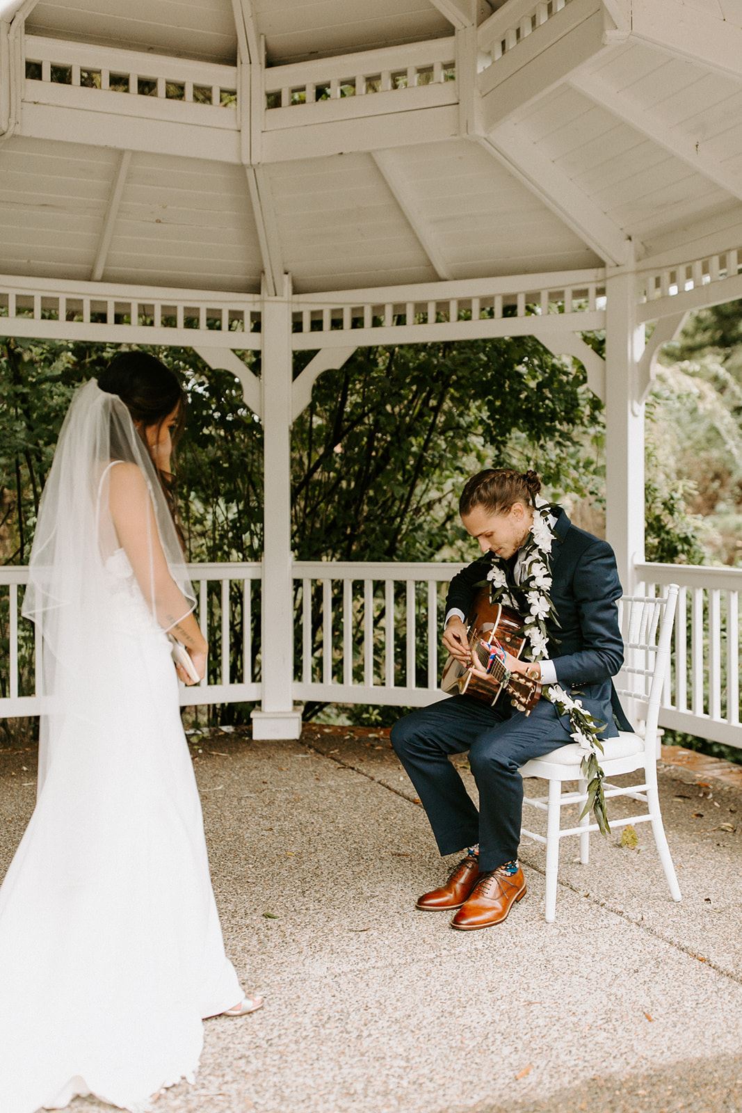 groom playing guitar during first look for bride in oregon city oregon