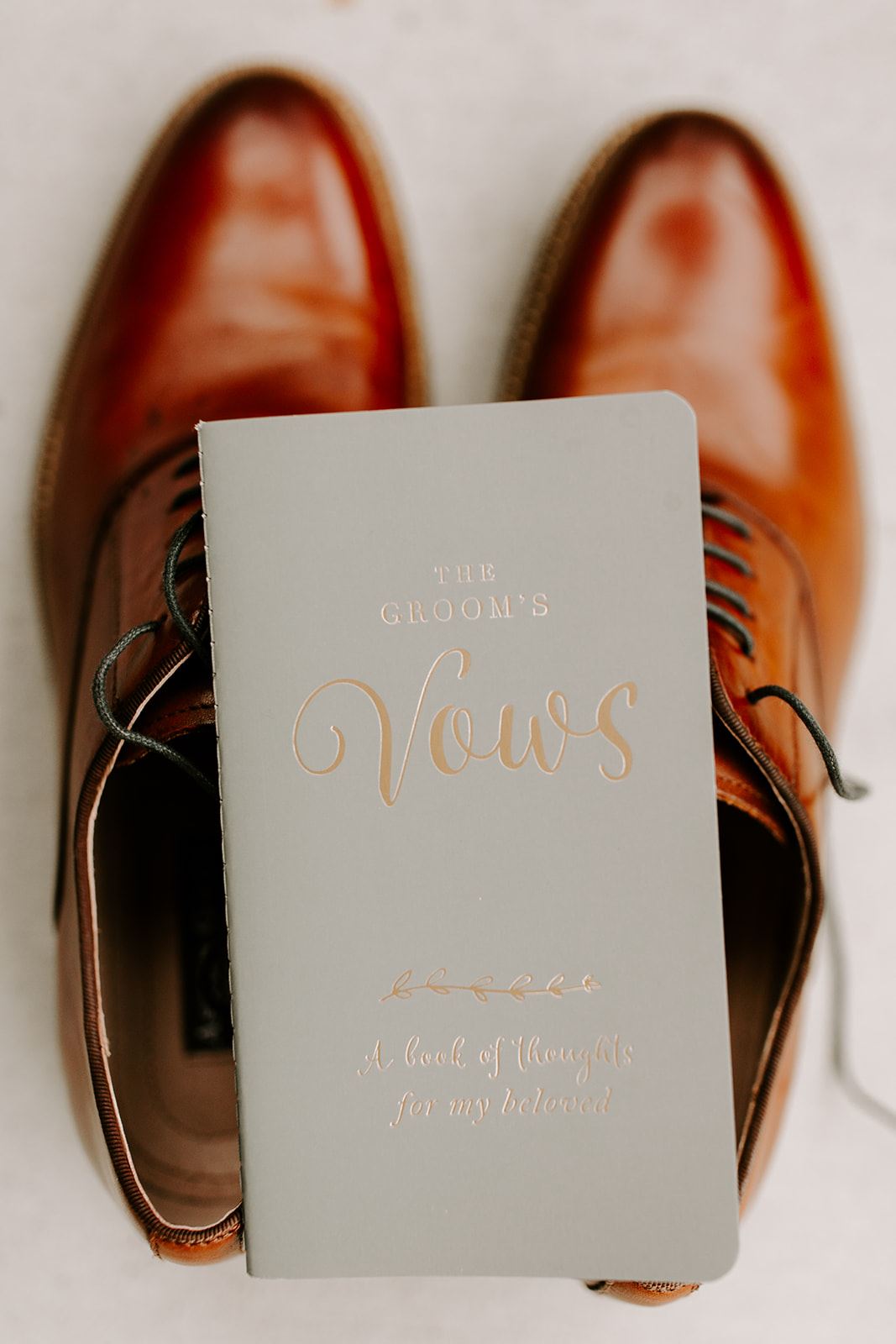 groom vow book with shoes