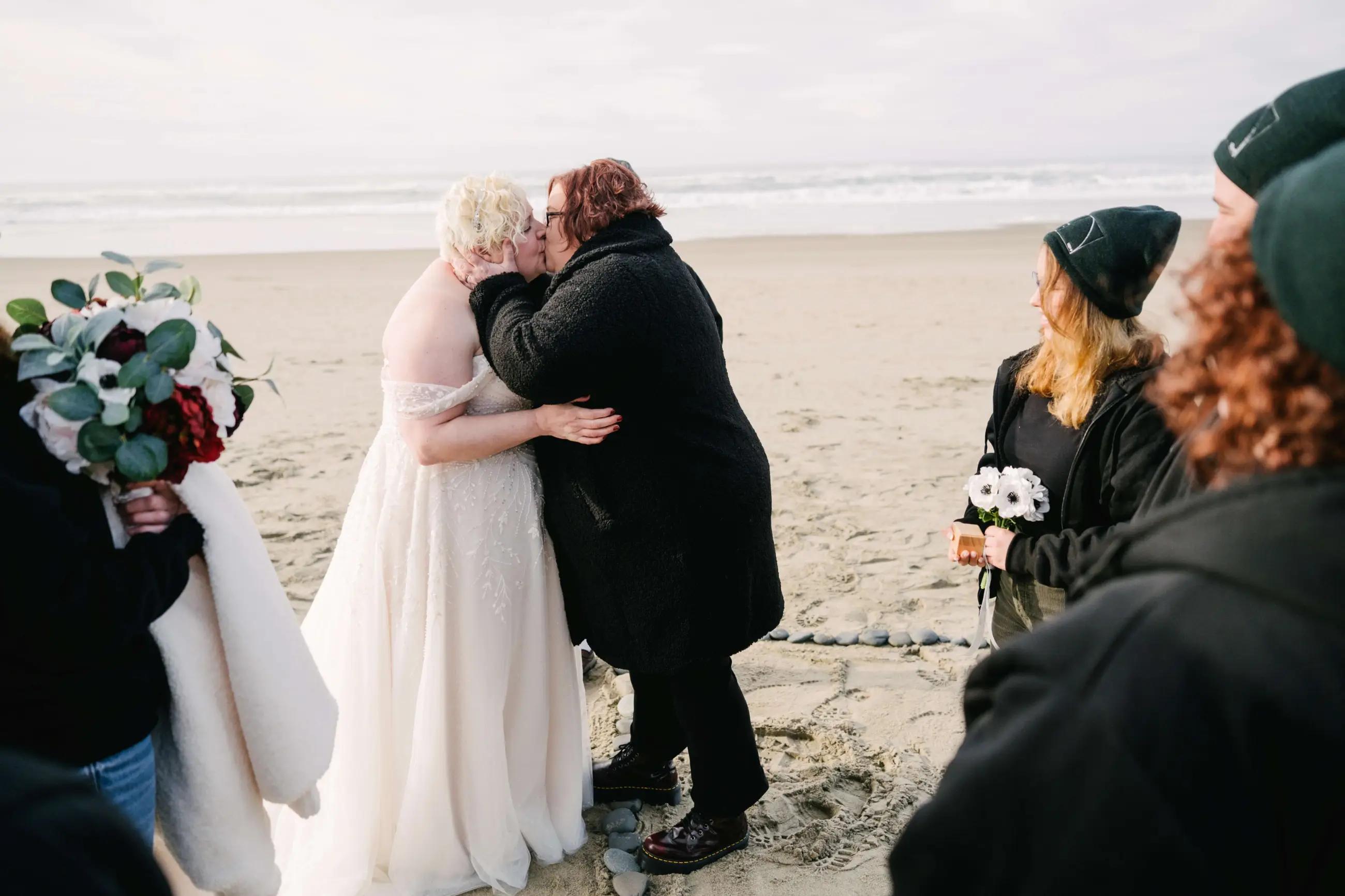 Two brides kissing on wedding day