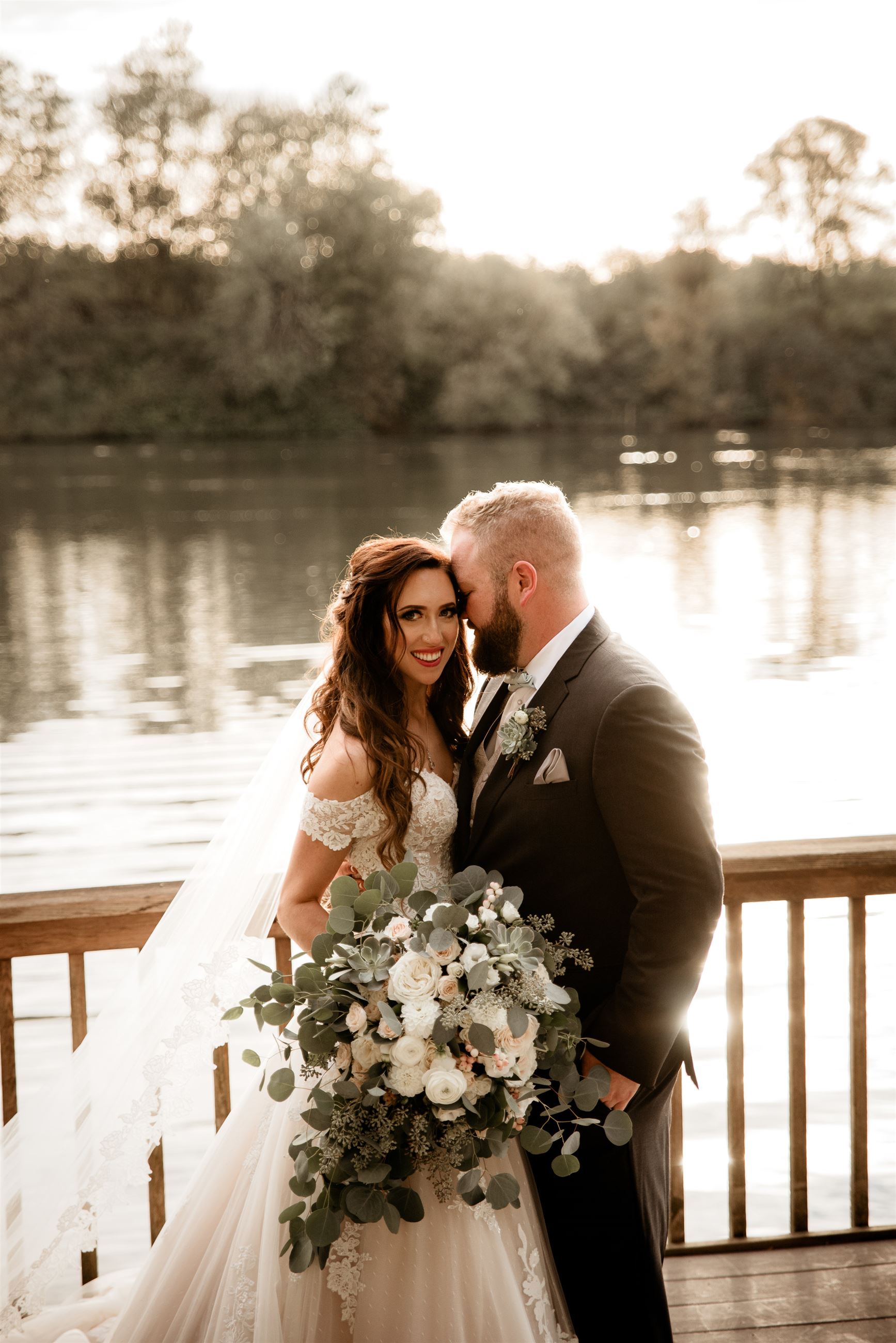 Bride and groom portrait by river