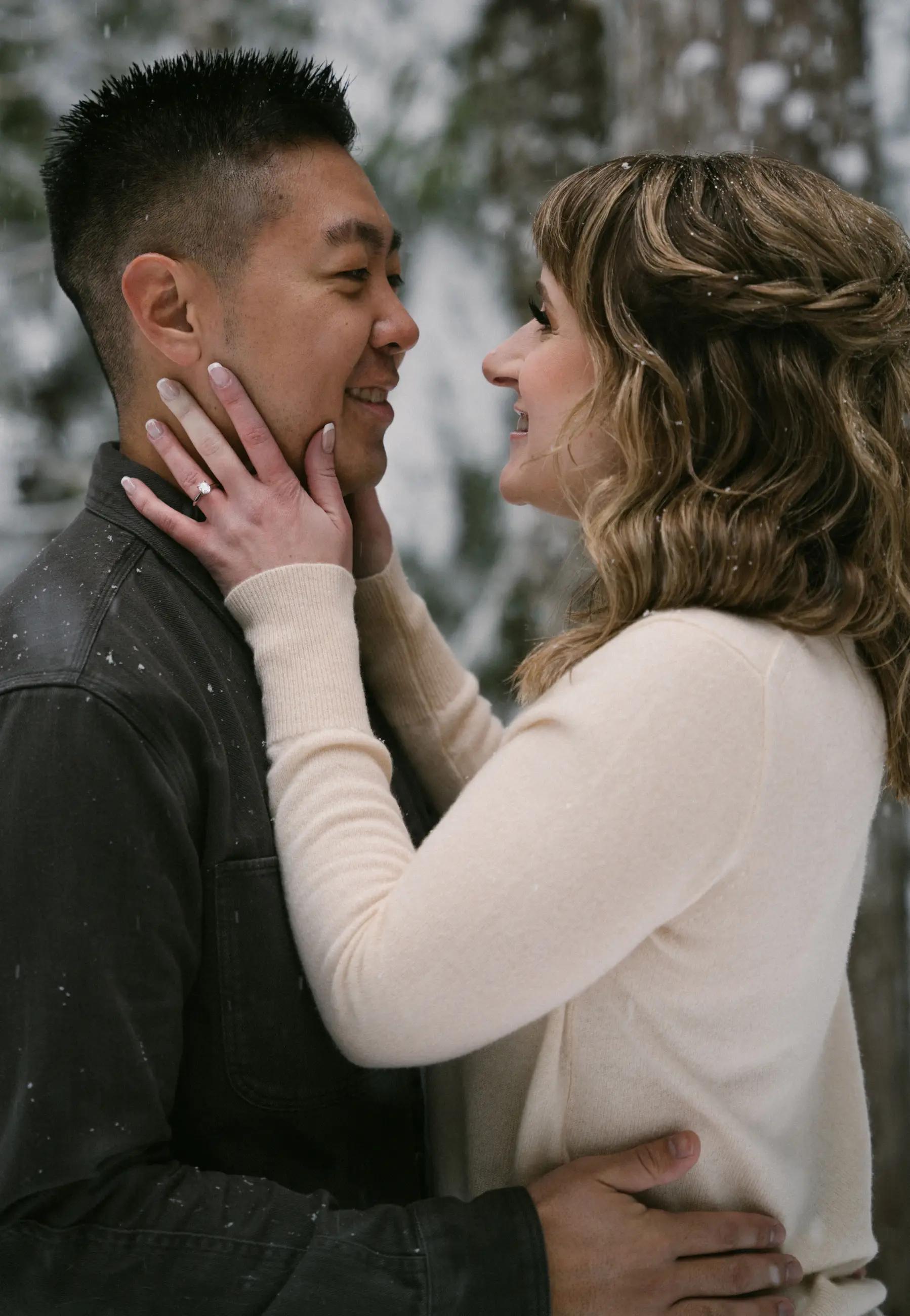 Photo of couple engagement in a snowy background