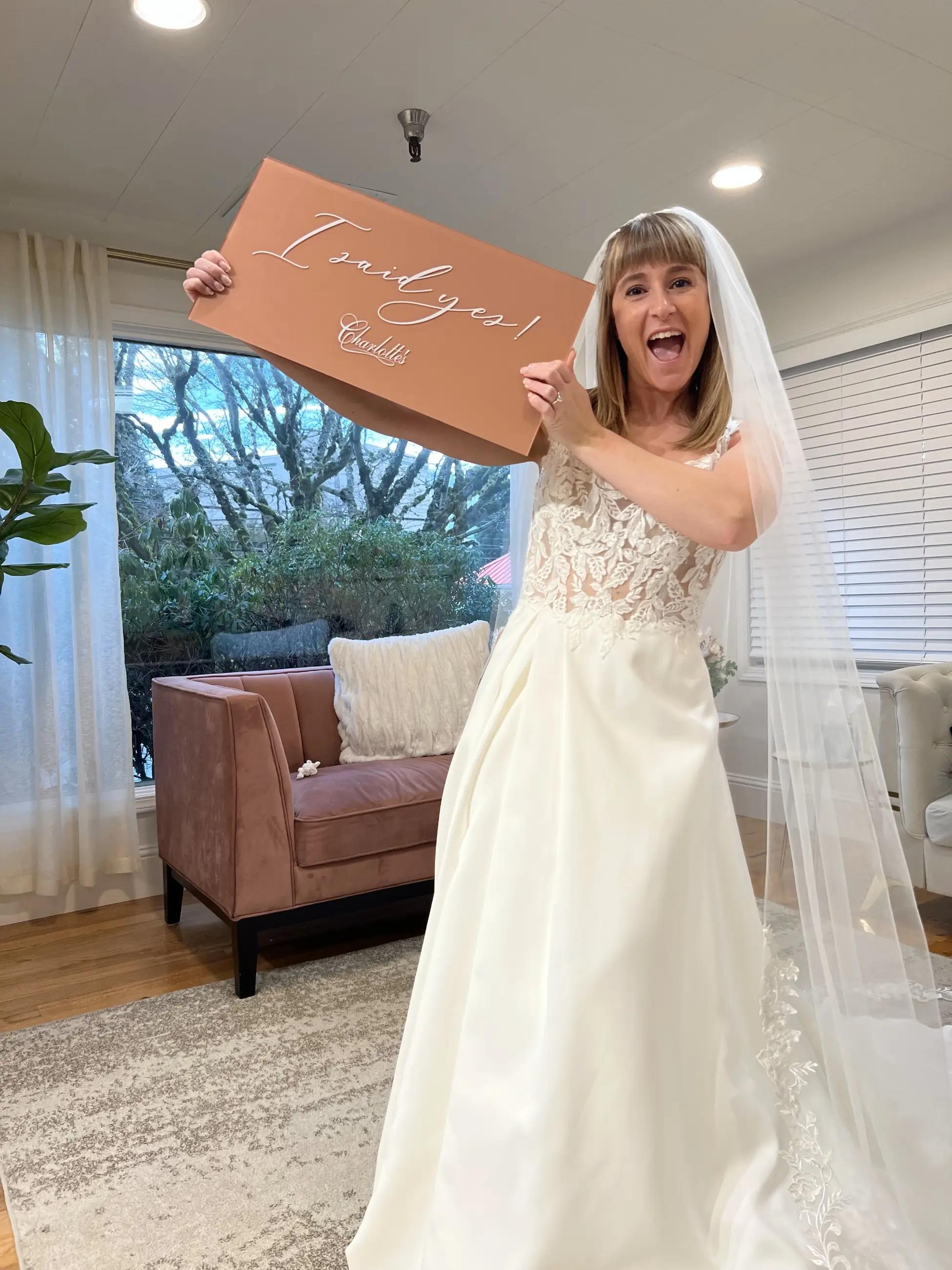 Bride at wedding dress shopping appointment, saying yes