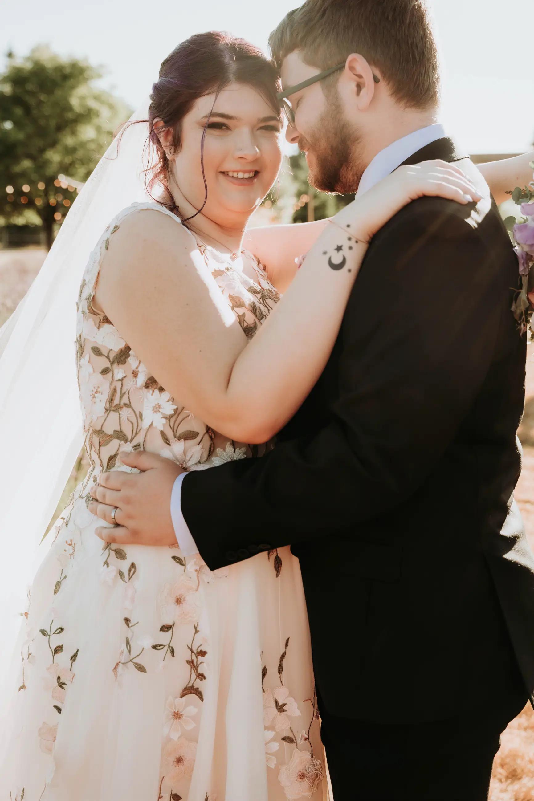 Photo of couple ay wedding, floral wedding gown